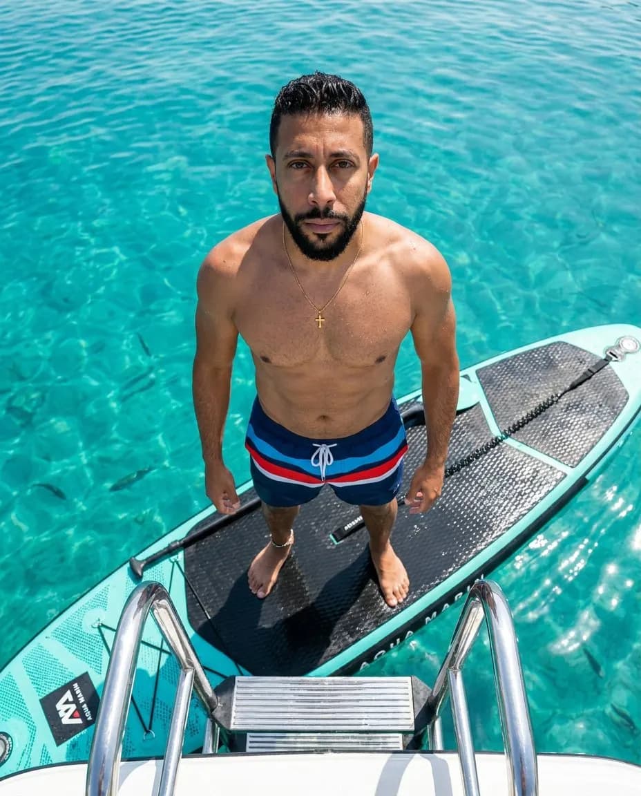 Aerial Cinematic Portrait of Athlete on Teal Paddleboard