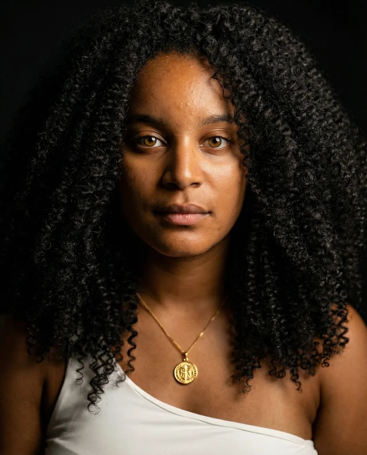 Editorial Portrait of Young African American Woman with Glowing Medallion